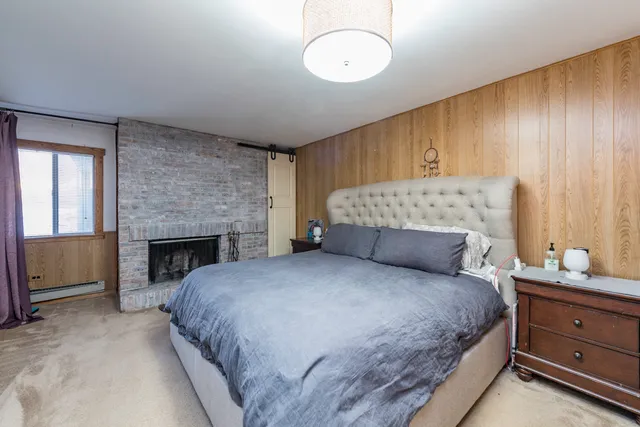 a bathroom with a granite countertop sink a toilet and a mirror