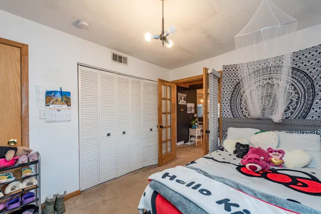 a bedroom with a bed and a flat screen tv