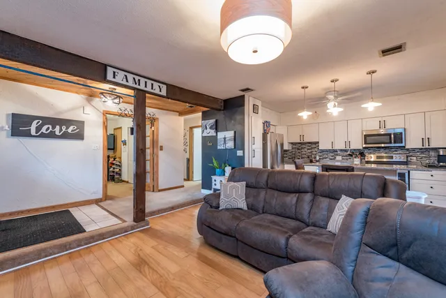 a living room with furniture and kitchen view