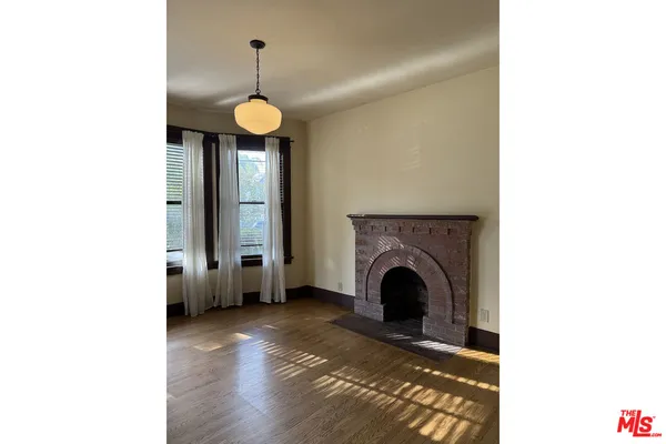 a view of a hallway with wooden floor and entryway