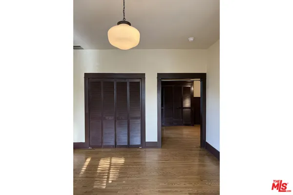 a view of an empty room with a kitchen