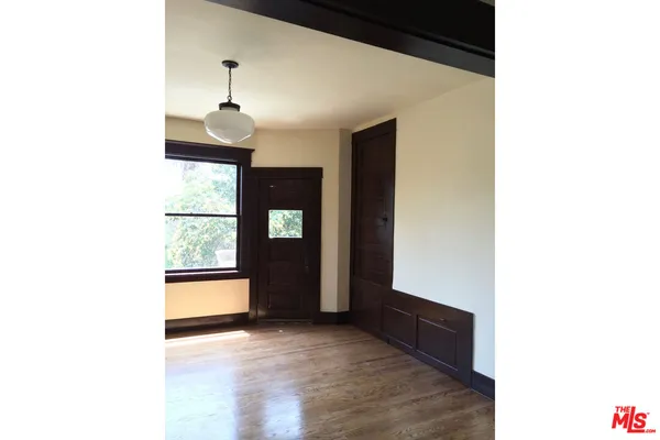 a view of a hallway with wooden floor and entryway