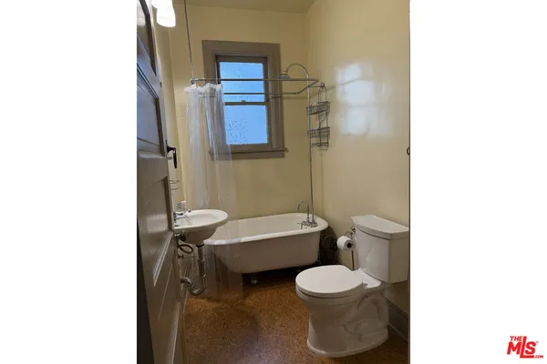 a bathroom with a shower and a sink