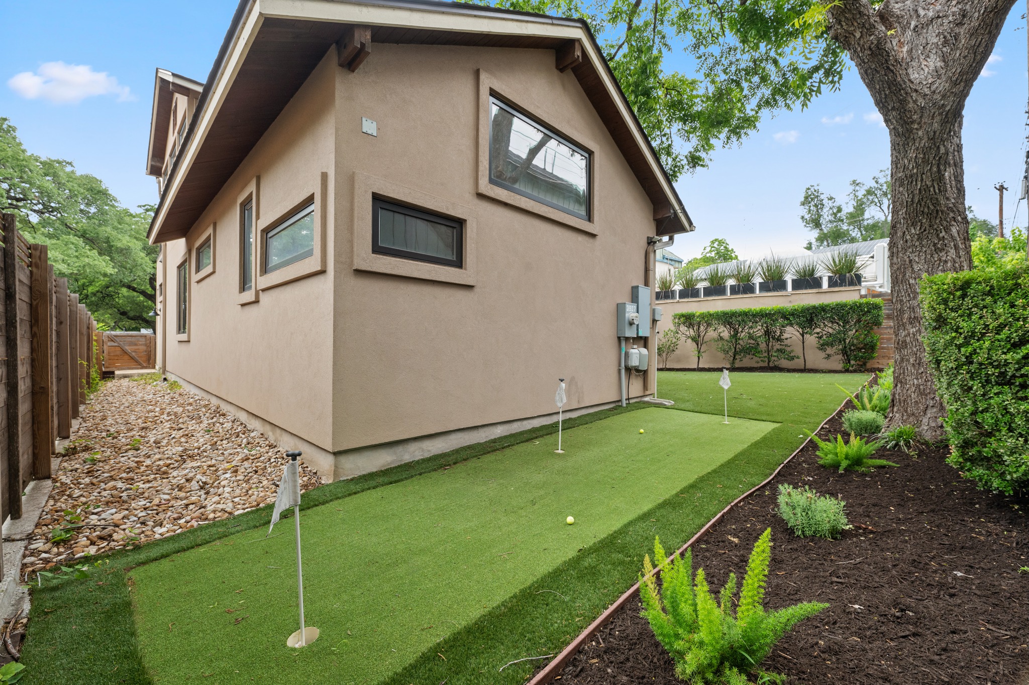 3907 Bailey Lane Austin, TX 78756 - Photo 32 of 40 Perfect your short game without leaving home on this professionally installed backyard putting green, the ultimate private retreat for golf enthusiasts and outdoor entertainment alike
