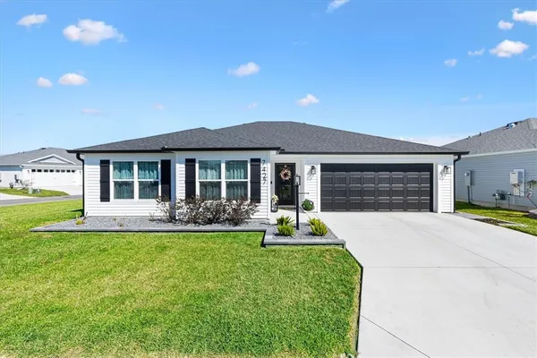 a front view of a house with swimming pool and garden