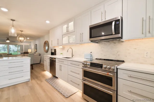 a kitchen with a sink stove and cabinets