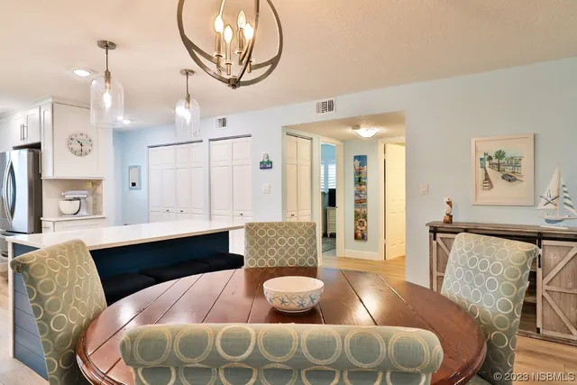 a view of a refrigerator in kitchen and wooden floor