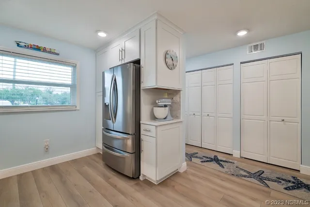 a view of washer and dryer with bathroom in the background