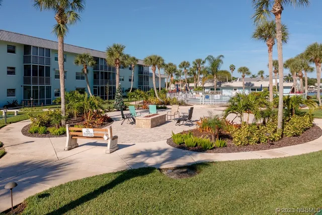 a view of a swimming pool with outdoor seating