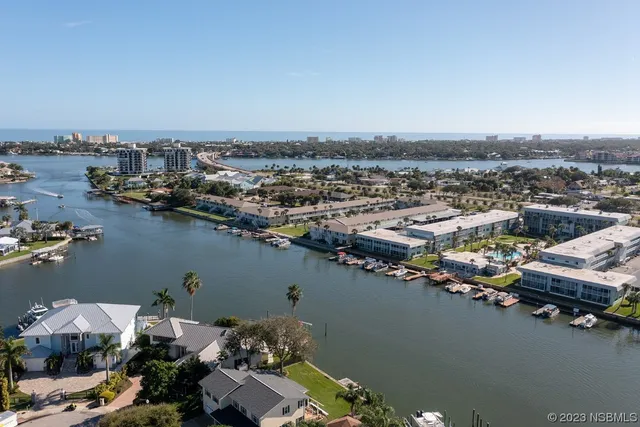 a view of a house with backyard sitting area and garden