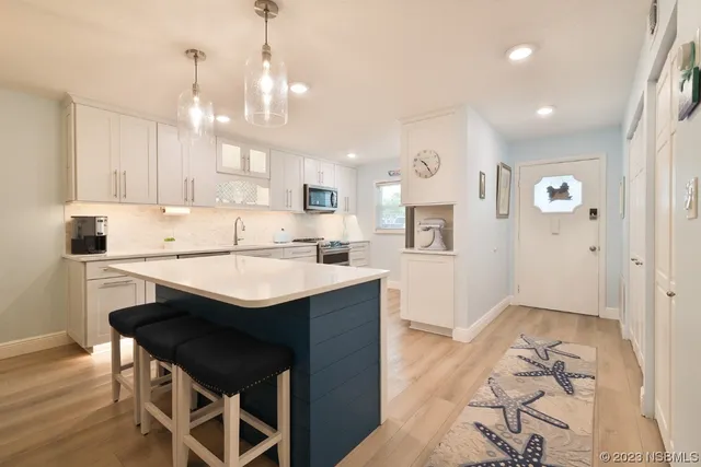 a large kitchen with a table and chairs