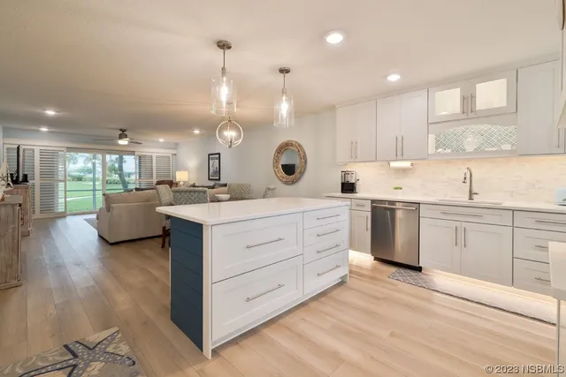 a kitchen with cabinets stainless steel appliances and a sink