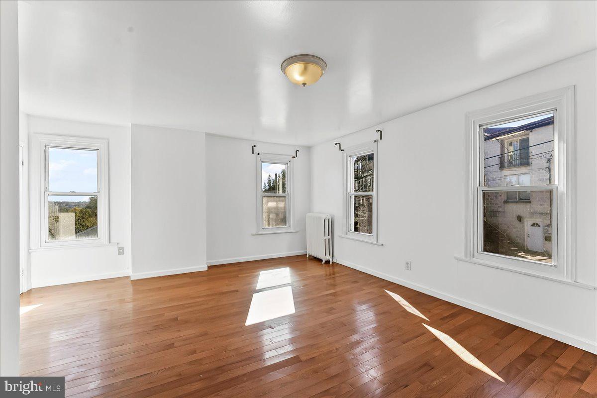 85 Price Street Bala Cynwyd, PA 19004 - Photo 17 of 44 a view of an empty room with wooden floor and a window