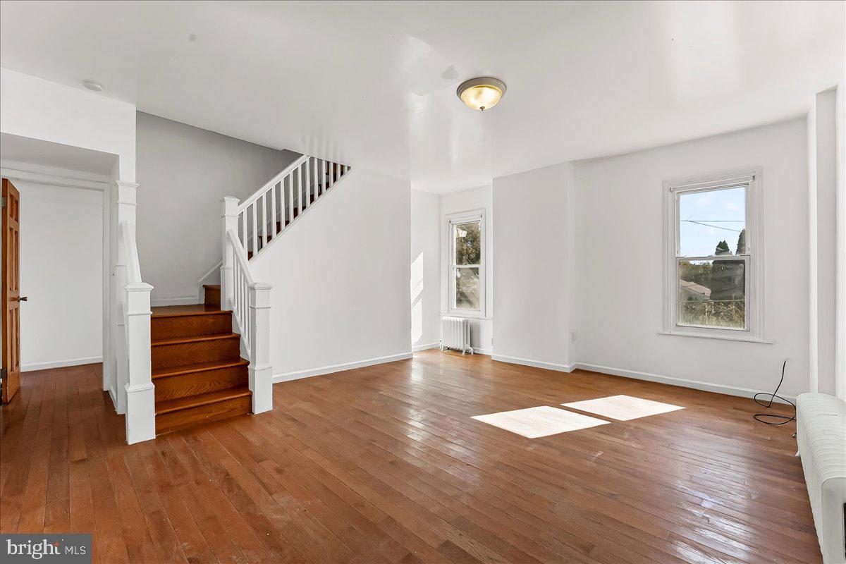 85 Price Street Bala Cynwyd, PA 19004 - Photo 3 of 44 an empty room with wooden floor and windows