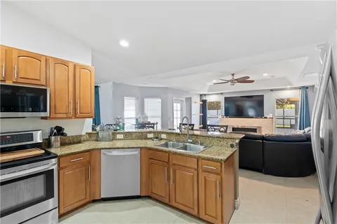 a kitchen with a sink stove top oven and refrigerator