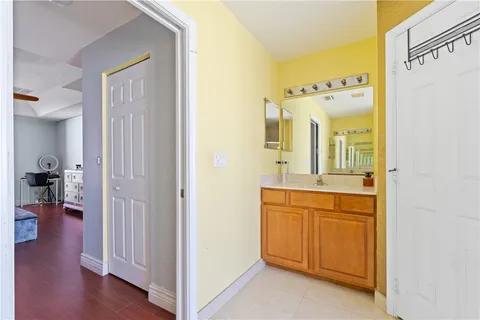 a en suite bathroom with a granite countertop sink and a mirror
