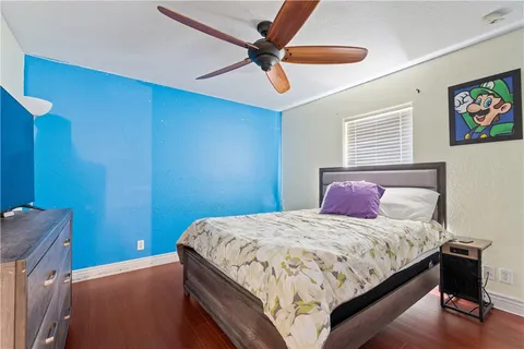 a bedroom with a bed and a chandelier
