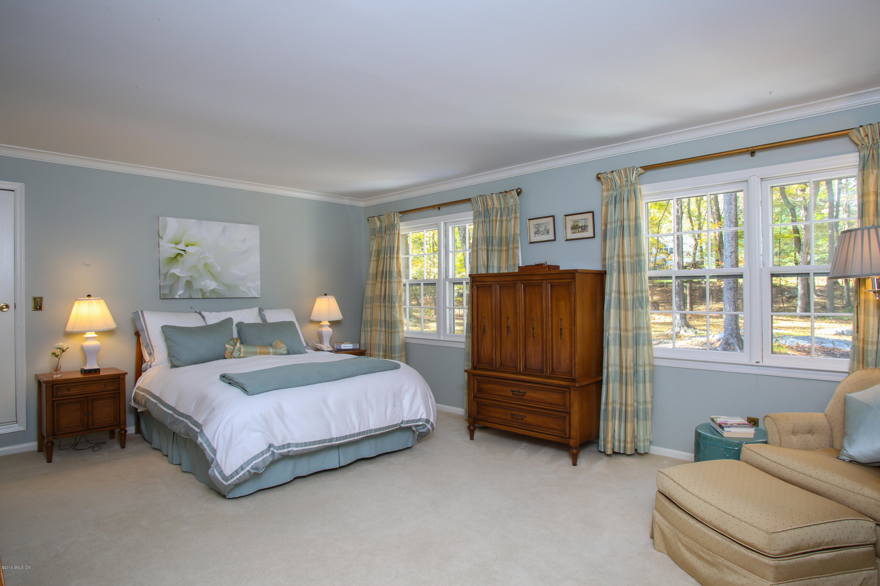 36 Burning Tree Road Greenwich, CT 06830 - Photo 12 of 25 a bedroom with a bed dresser and a window