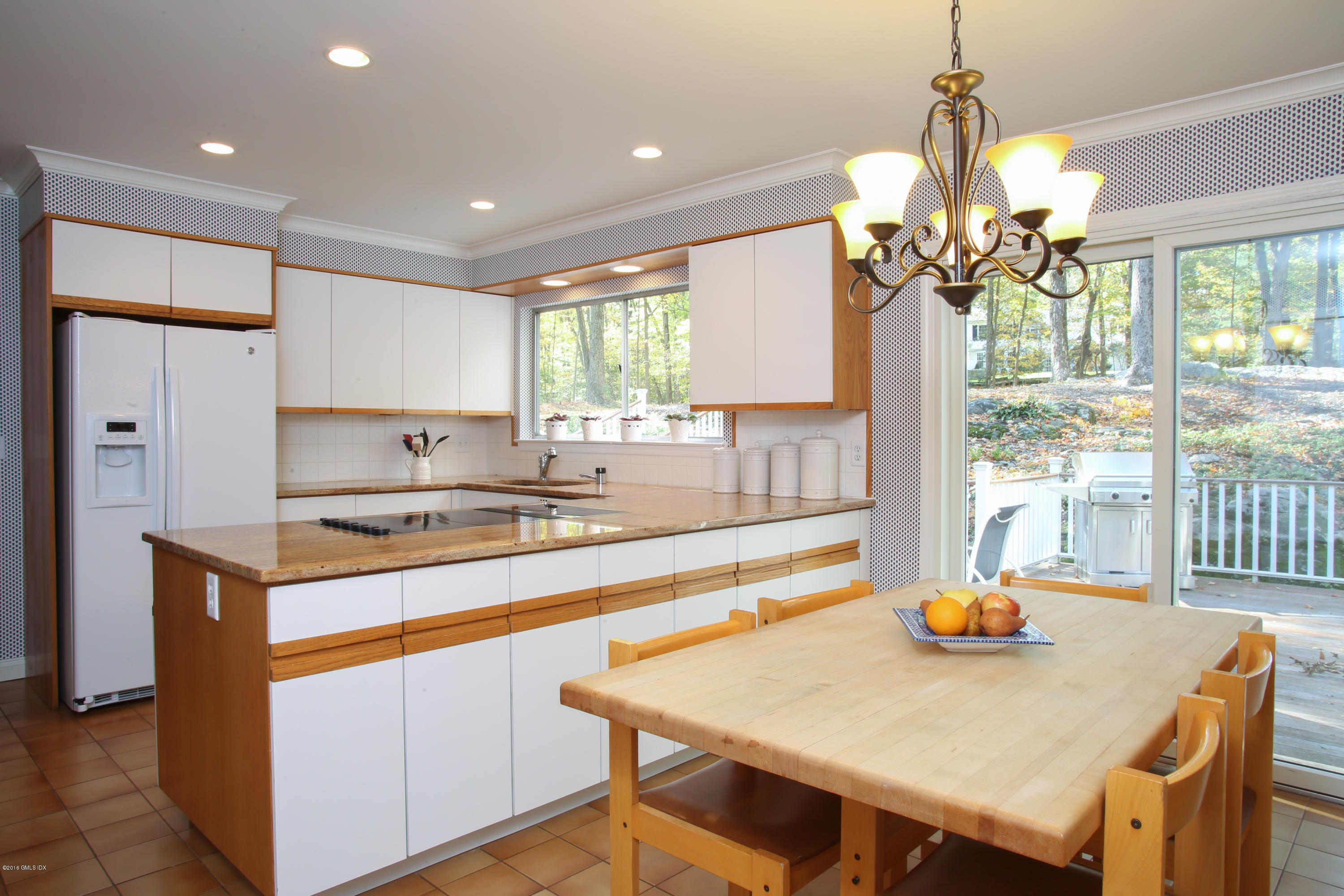 36 Burning Tree Road Greenwich, CT 06830 - Photo 17 of 25 a kitchen with a table a sink and refrigerator