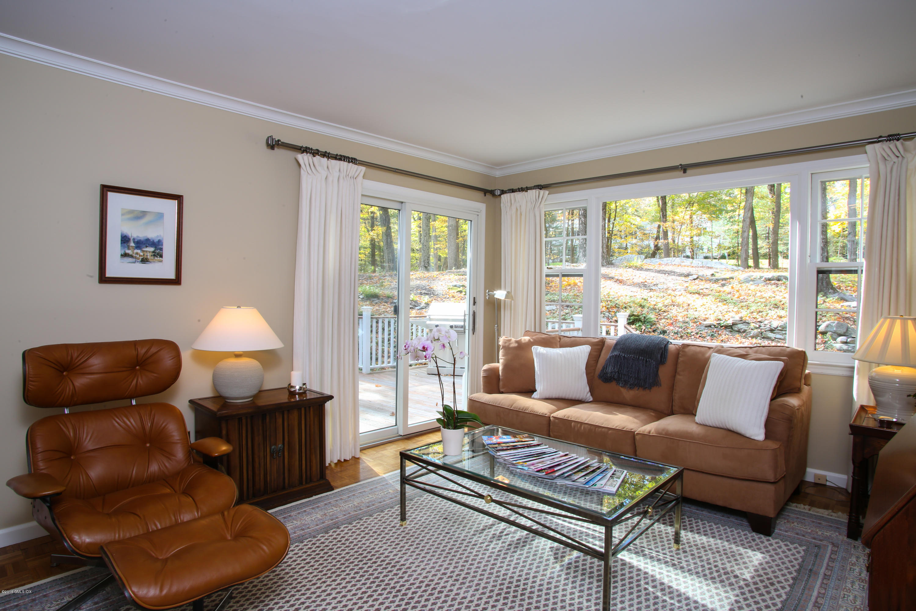 36 Burning Tree Road Greenwich, CT 06830 - Photo 19 of 25 a living room with furniture and a lamp