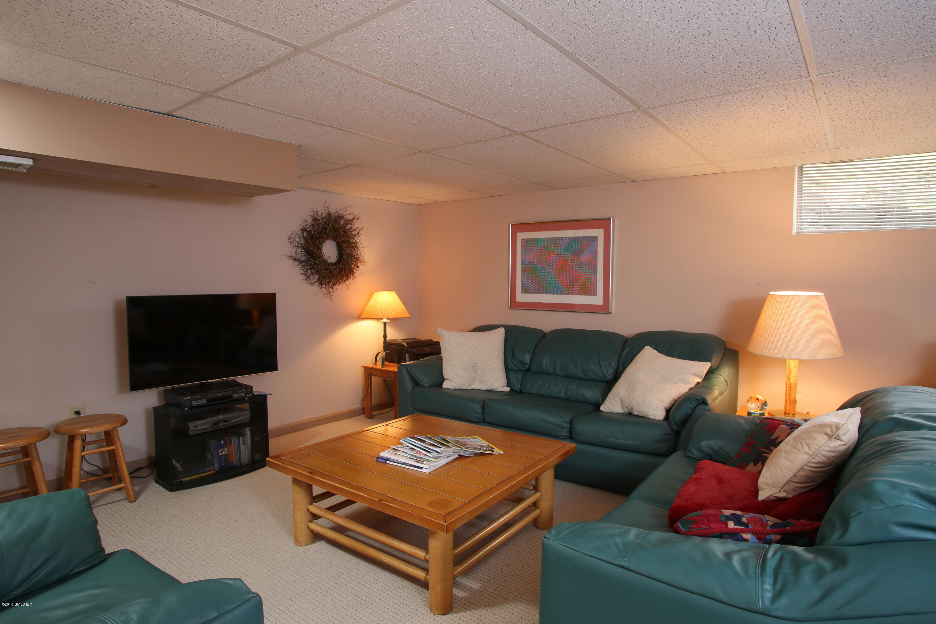 36 Burning Tree Road Greenwich, CT 06830 - Photo 20 of 25 a living room with furniture and a flat screen tv