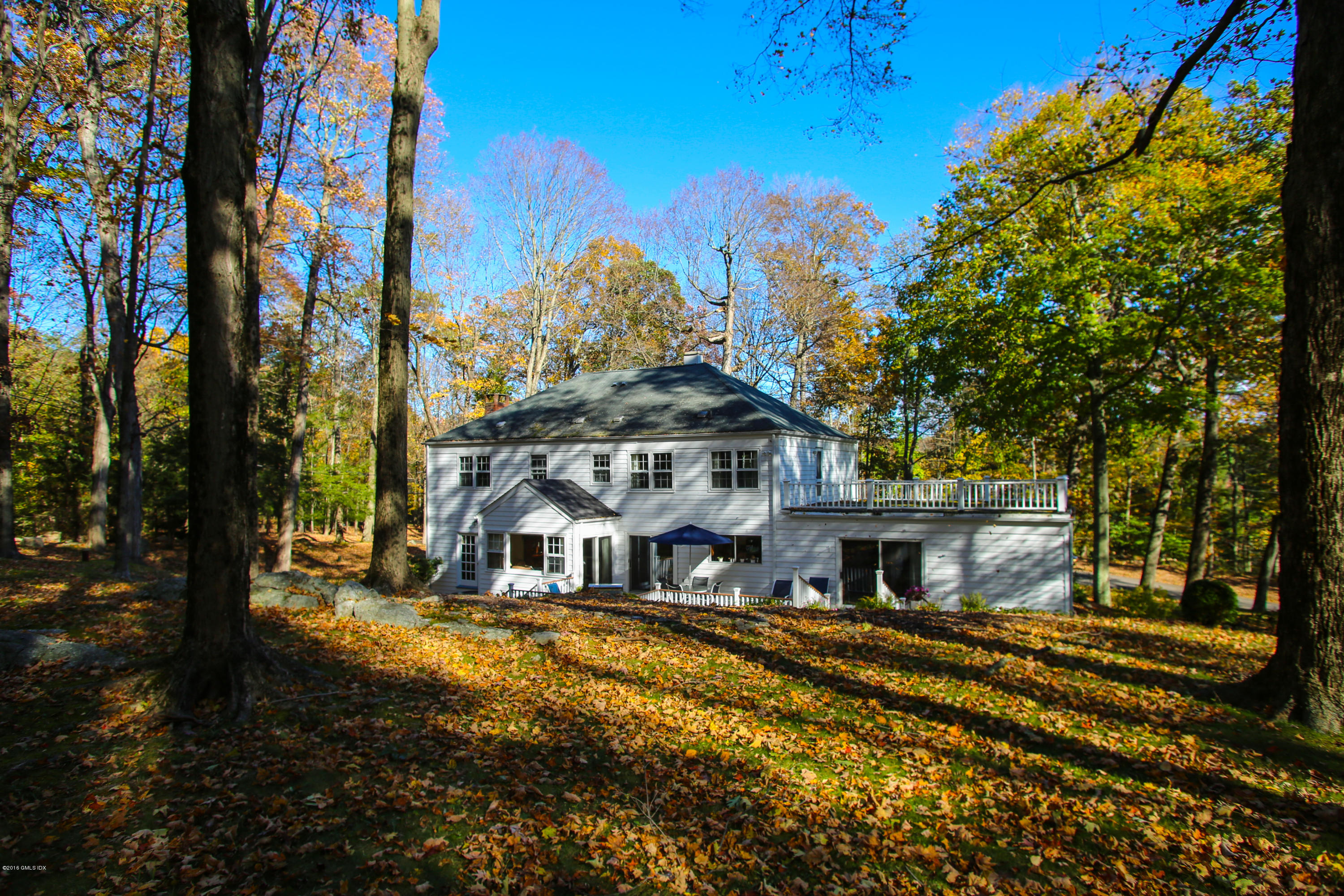 36 Burning Tree Road Greenwich, CT 06830 - Photo 24 of 25 a front view of a house with a yard
