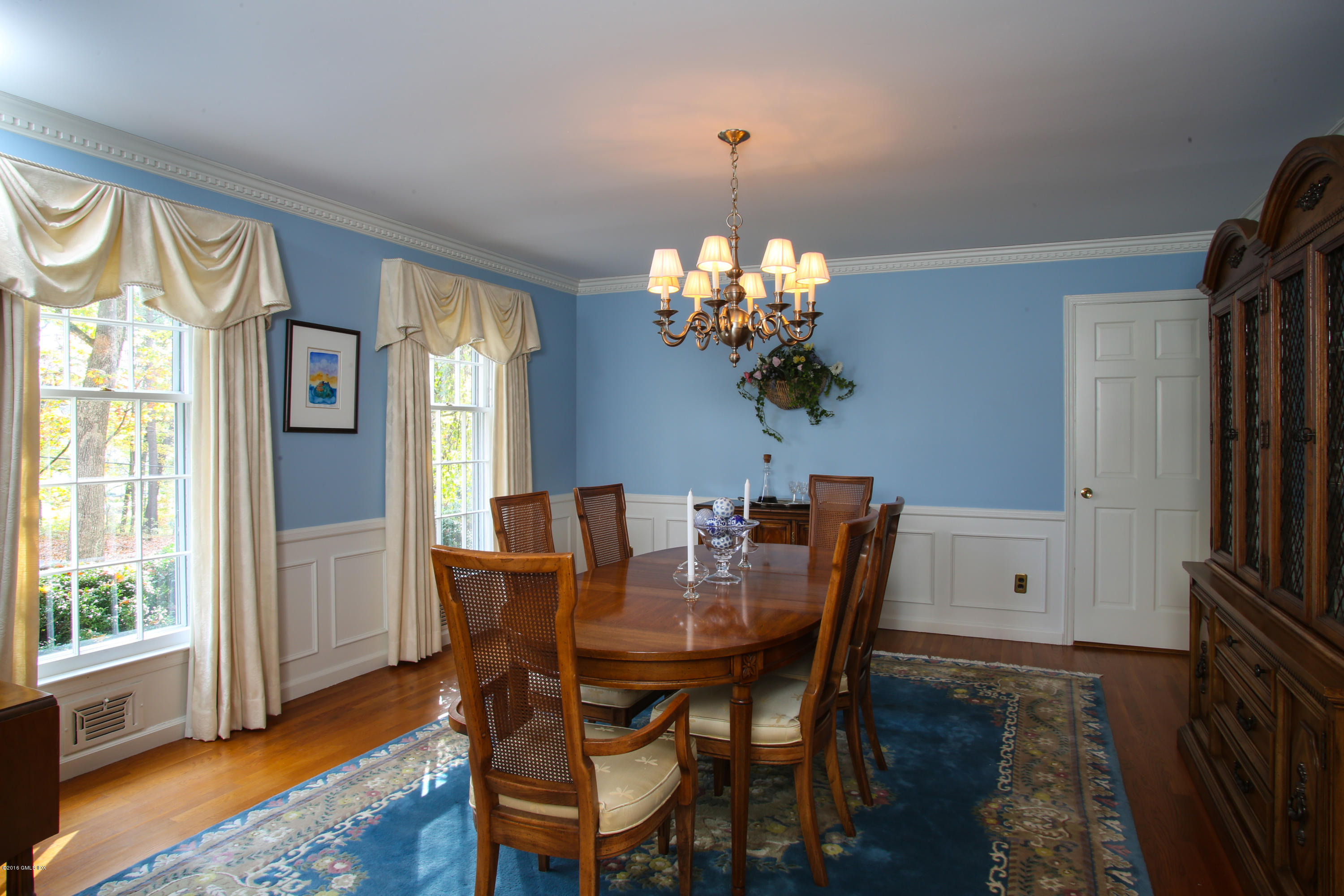 36 Burning Tree Road Greenwich, CT 06830 - Photo 7 of 25 a view of a dining room with furniture a chandelier and wooden floor