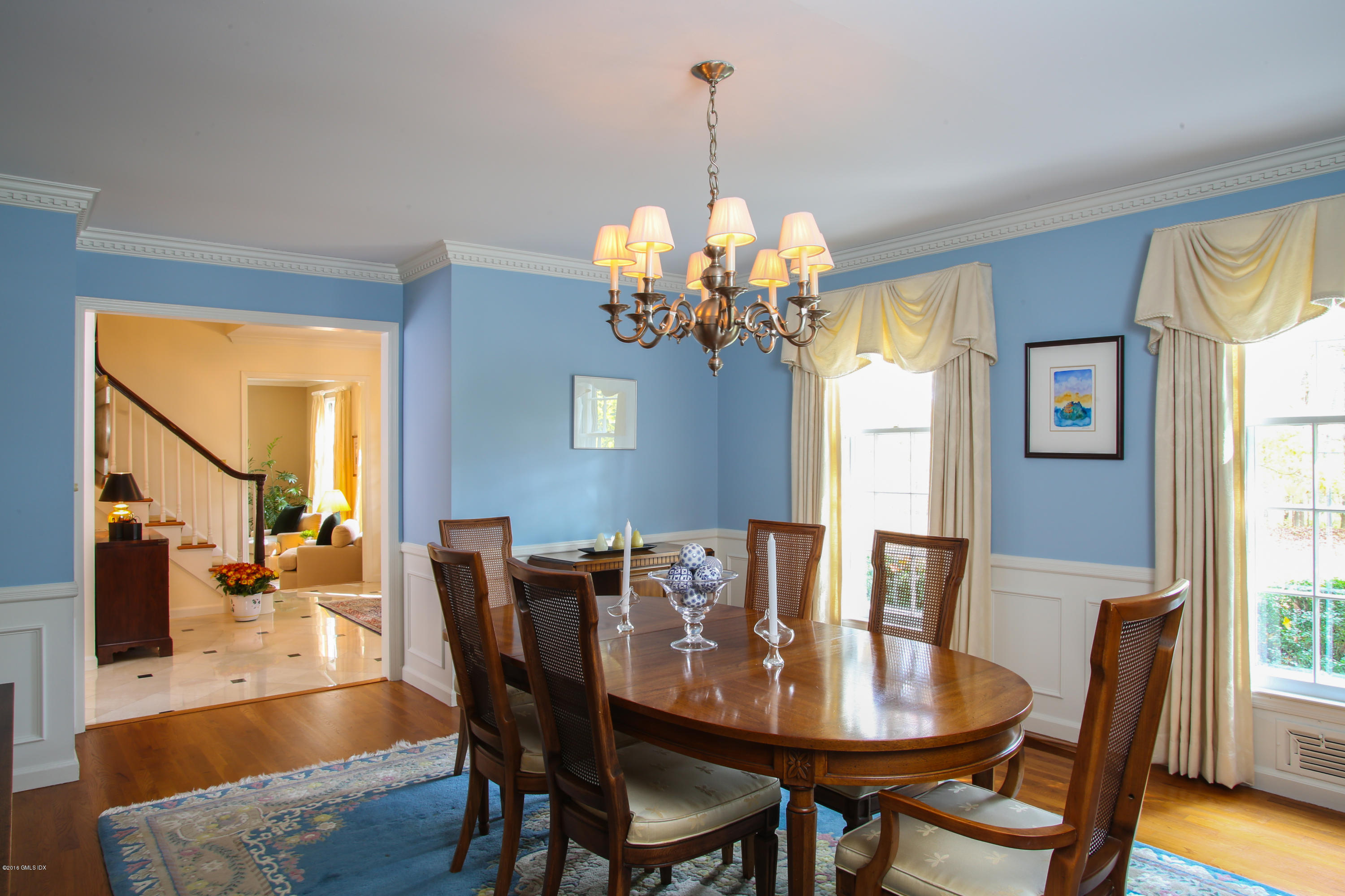 36 Burning Tree Road Greenwich, CT 06830 - Photo 8 of 25 a view of a dining room with furniture a chandelier and wooden floor