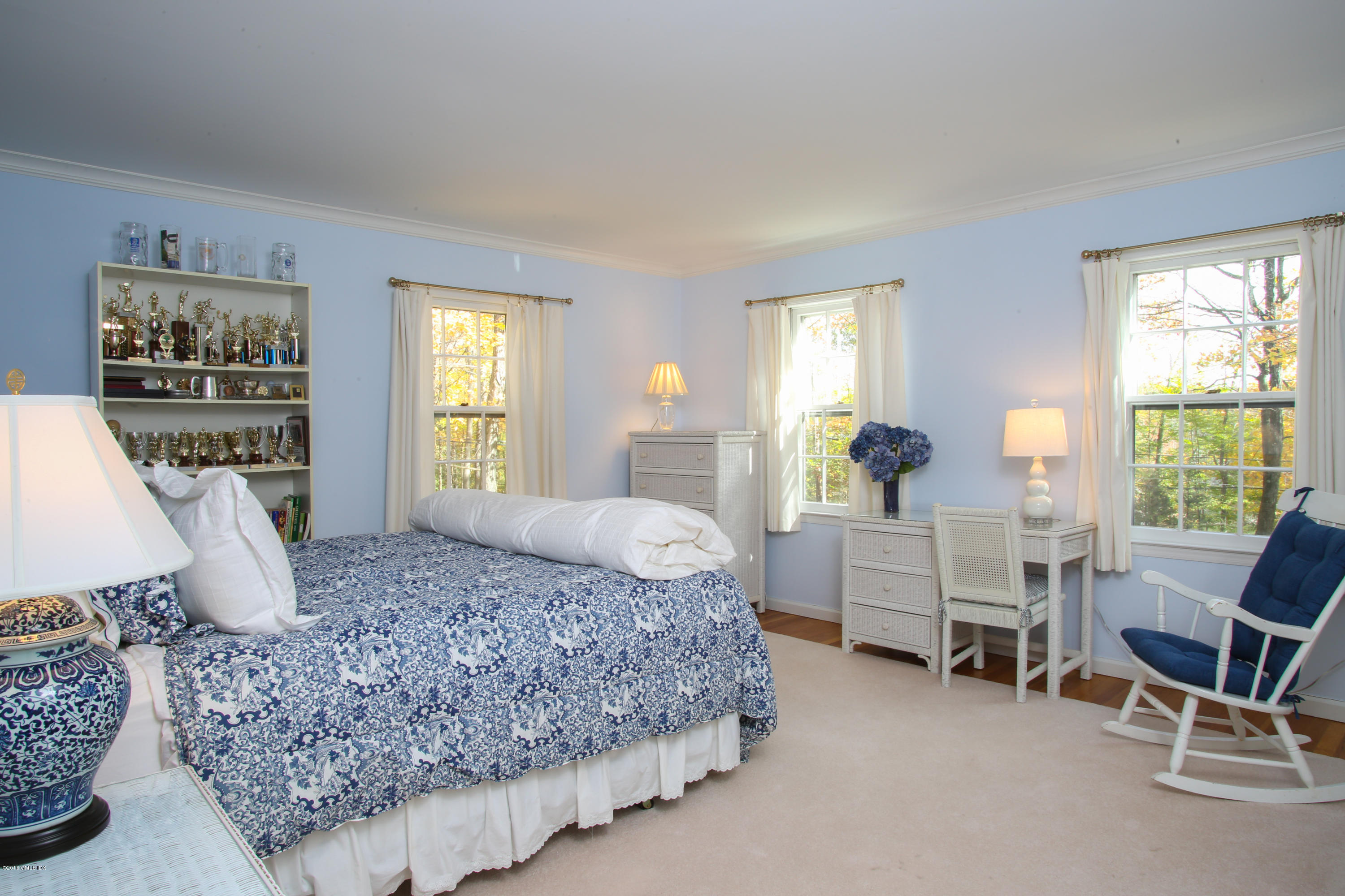 36 Burning Tree Road Greenwich, CT 06830 - Photo 9 of 25 a bedroom with a bed a table and chair