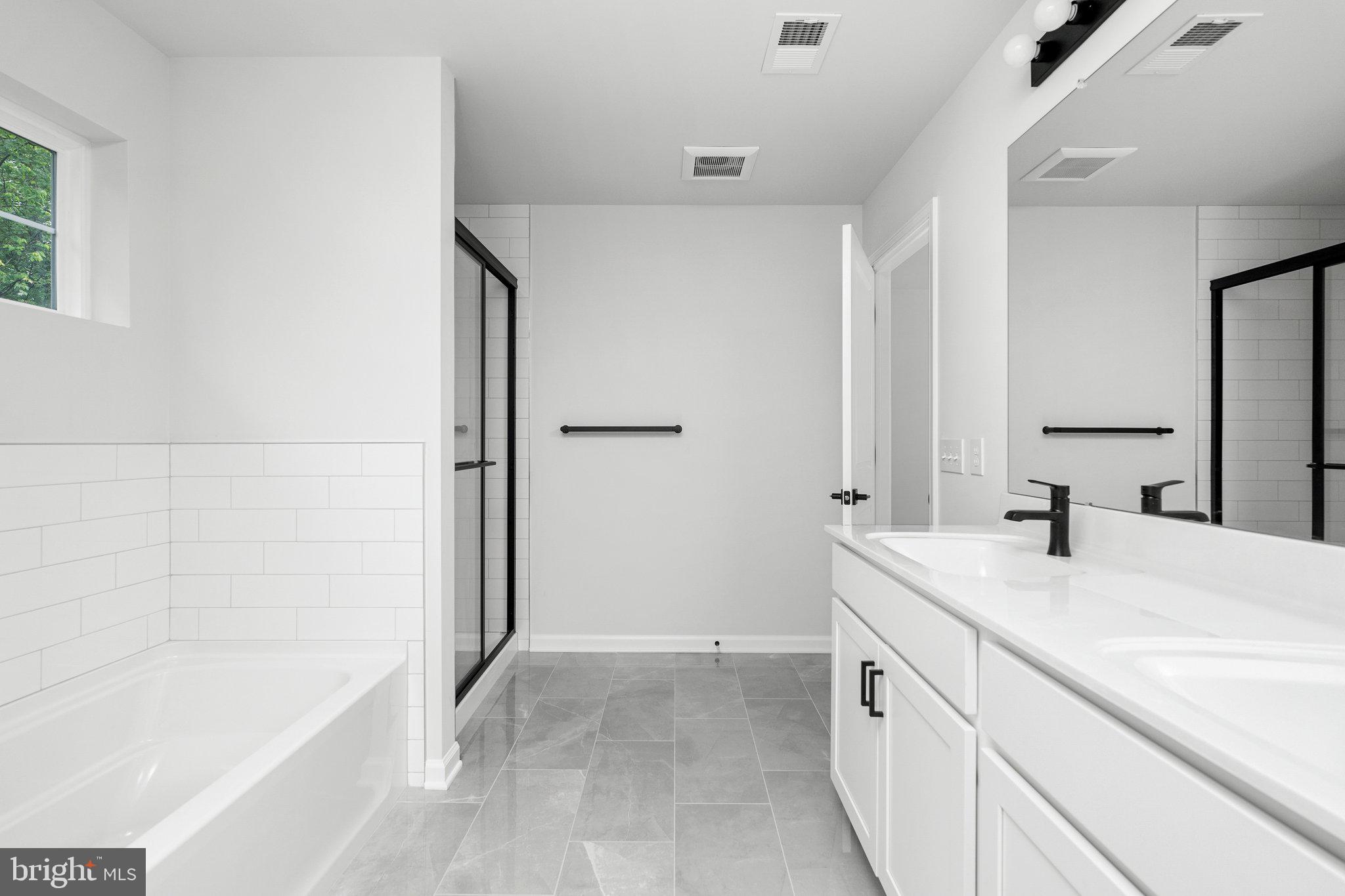 4913 South Broad Street Hamilton, NJ 08620 - Photo 16 of 31 a spacious bathroom with a tub sink and a mirror