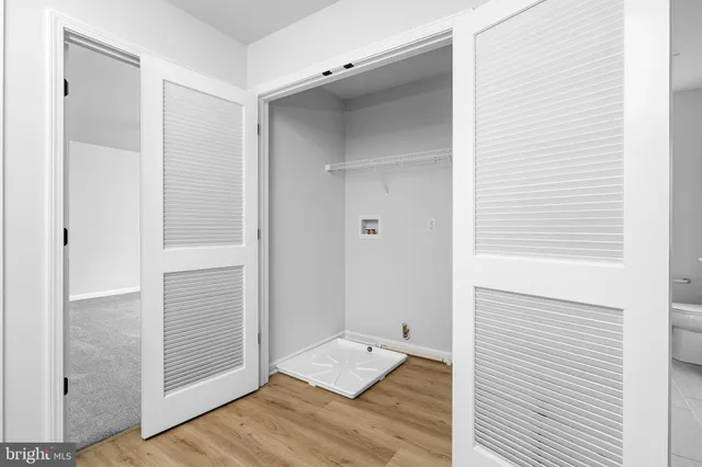 a view of walk in closet with empty room