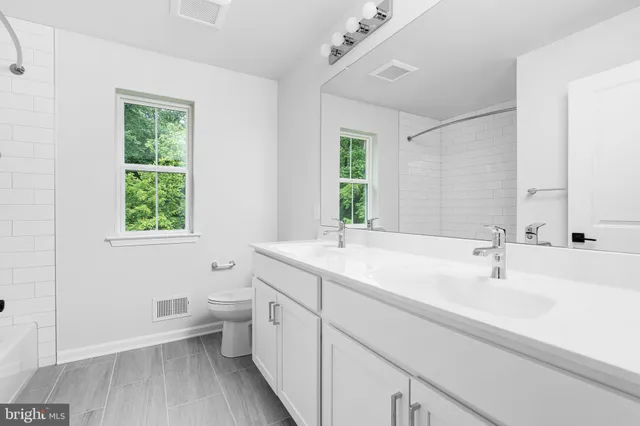 a bathroom with a toilet a sink and a window