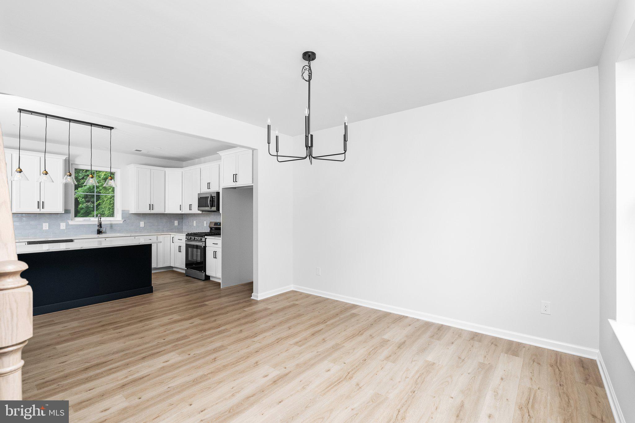 4913 South Broad Street Hamilton, NJ 08620 - Photo 5 of 31 a kitchen with stainless steel appliances kitchen island a hardwood floor and a sink