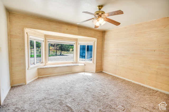 2373 East 190 North Beaver, UT 84713 - Photo 33 of 54 Carpeted spare room with a ceiling fan and wood walls