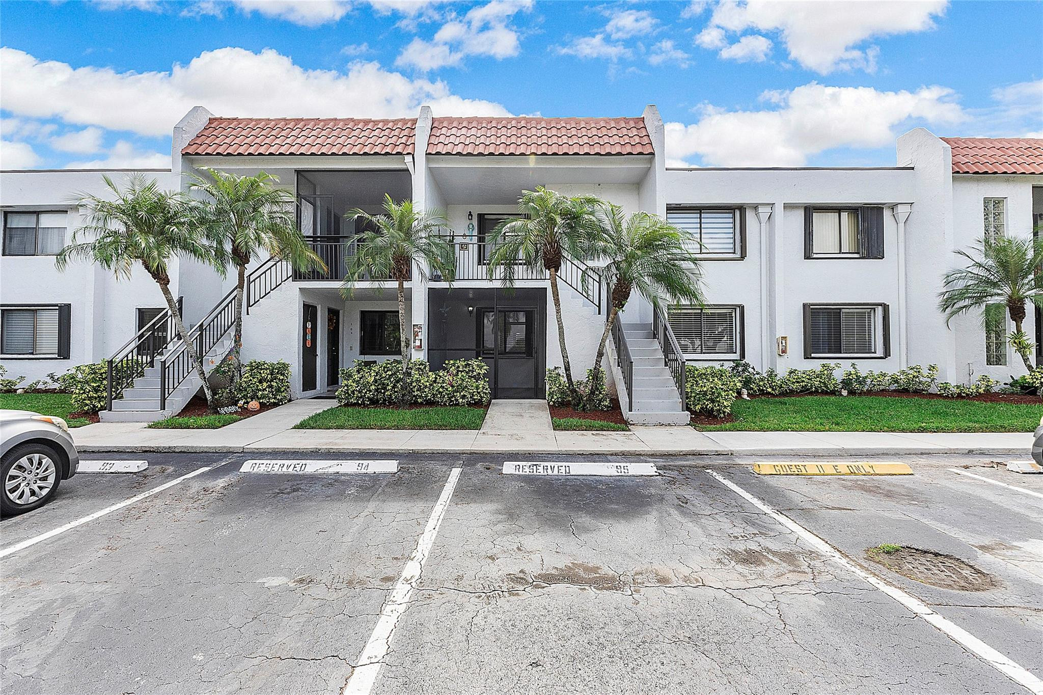 300 Racquet Club Road, Unit 105 Weston, FL 33326 - Photo 1 of 14 a front view of a house with a yard and garage