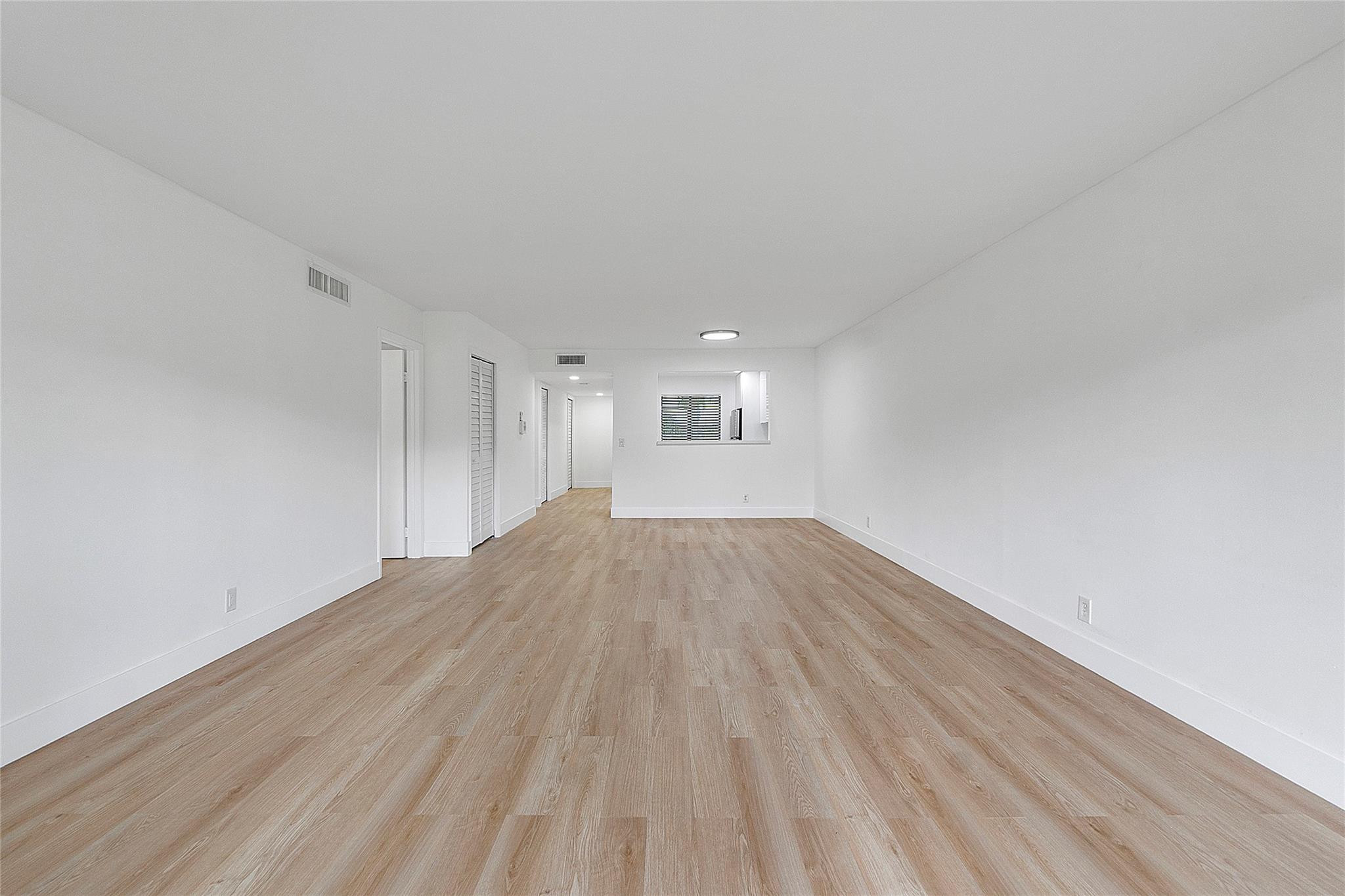 300 Racquet Club Road, Unit 105 Weston, FL 33326 - Photo 7 of 14 a view of empty room with wooden floor