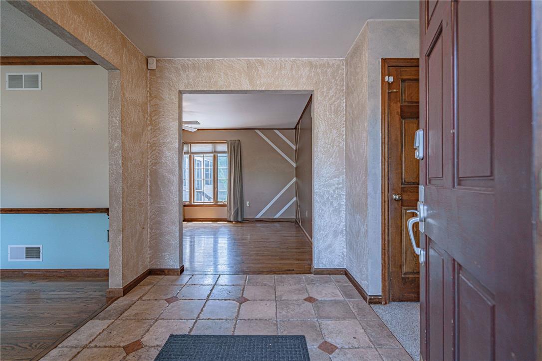 652 Old State Road Oley, PA 19547 - Photo 10 of 54 A welcoming entryway with patterned tile flooring transitions seamlessly into a living space with wood floors.