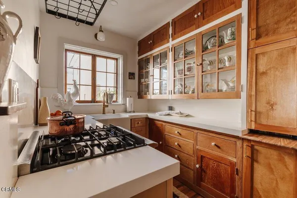 a kitchen with stainless steel appliances a sink stove and a window
