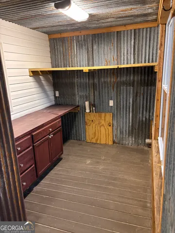 a view of outdoor kitchen and wooden floor