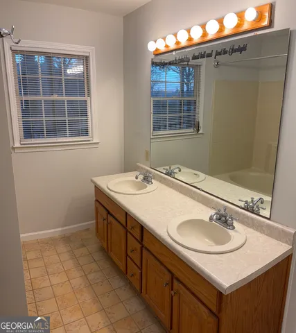 a bathroom with a sink a vanity and a mirror