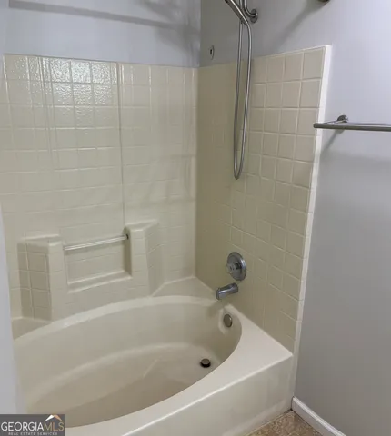 a white bath tub and a shower