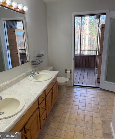 a bathroom with a sink a toilet and mirror