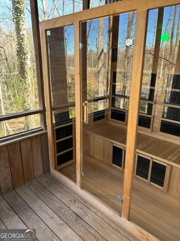 a view of a balcony with wooden floor and door