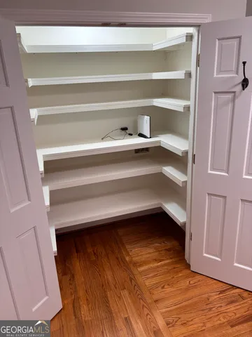 a view of walk in closet with empty racks