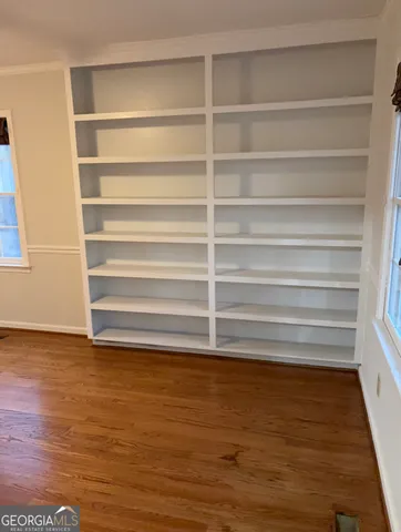 a view of walk in closet with empty racks
