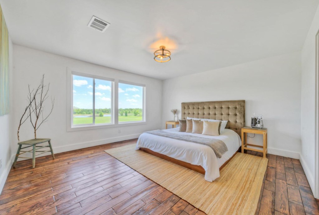 3 County Road, Unit 3 Elgin, TX 78621 - Photo 17 of 37 a spacious bedroom with a bed and a window