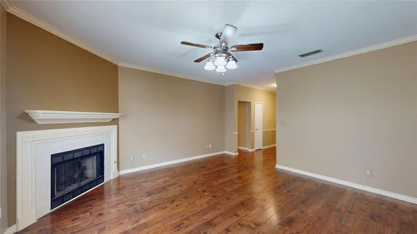 a view of an empty room with a fireplace and a window