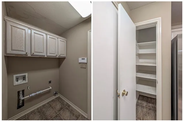 a view of a utility room with closet empty shelves