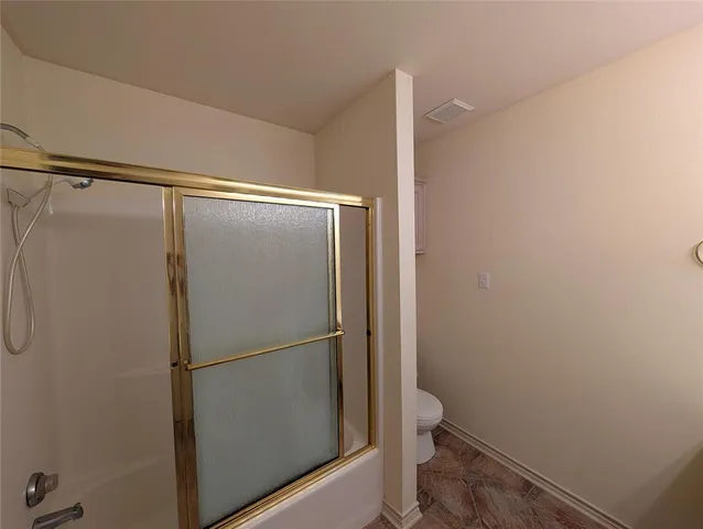 a bathroom with a glass shower door