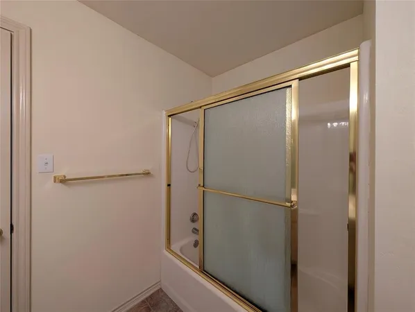 a bathroom with a glass shower door